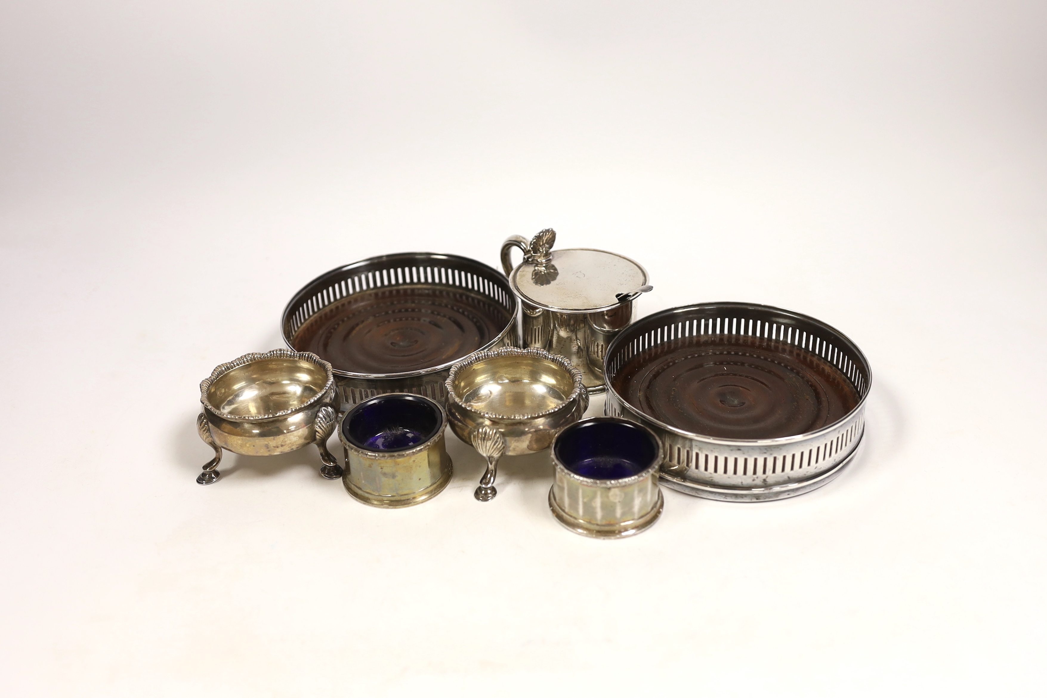 An early Victorian Scottish silver drum mustard, Edinburgh, 1844?, 7cm, two pairs of silver salts including pair by David & Robert Hennell, London, 1766 and a pair of silver plated wine coasters.